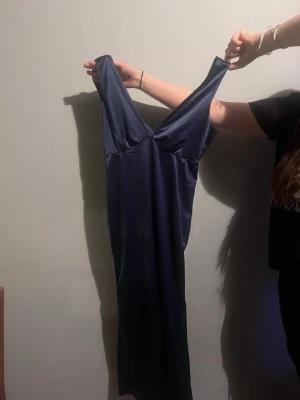 Marinblå långklänning med v-ringning - Elegant marinblå långklänning med djup v-ringning, dragkedja vid midjan och breda axelband. Perfekt till din bal, dejt eller bara till sommaren!🫶🏻