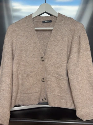 Beige kofta från Gina Tricot - Mysig beige kofta från Gina Tricot som tyvärr inte kommer till användning, inga defekter men lite nopprig som syns på sista bilden!