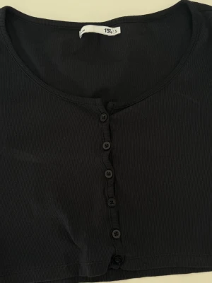 Black button top  - Black button top   Size: S Condition: used, in good condition  Details: button front, slightly faded black/grey tone  💰 Price: 80 kr  📦 Fast shipping / meet-up possible Message me if interested 💌