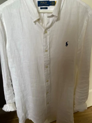Vit linneskjorta från Polo Ralph Lauren - Riktigt snygg linneskjorta från Ralph lauren som passar perfekt nu till sommaren. Endast använd en gång och inga defekter eller synligt slitage. Storlek L. Nypris:1400 Mitt pris:899 | Hör av dig för fler bilder eller frågor.