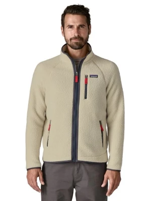 Beige fleecejacka från Patagonia - Beige fleecejacka från Patagonia med hel dragkedja, hög krage och tre fickor med dragkedja. Jackan har kontrastdetaljer i mörkgrått och röda dragkedjor. Tillverkad i mjukt och värmande fleecematerial, perfekt för kyliga dagar.