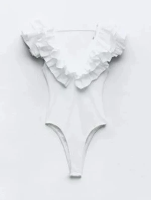 Vit body med volang från Zara - Supersnygg vit body från Zara med breda volanger runt ringningen som ger en trendig och romantisk look. Djup urringning och hög benskärning. Tillverkad i stretchigt material som sitter bekvämt och formar sig efter kroppen. Perfekt till sommarn💗