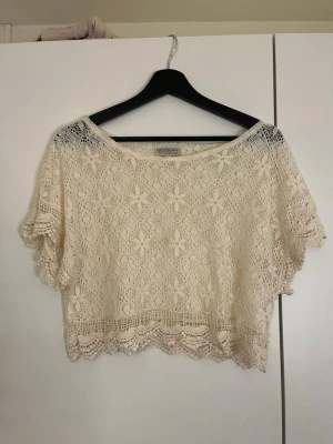 Beige spetsig croppad topp Bik Bok - Säljer en beige croppad topp från Bik Bok i spets med korta ärmar