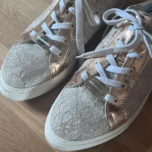 Snygga sneakers i stl 37, använda ett fåtal gånger. Guld och spetsfetaljer. Nypris 1000kr 