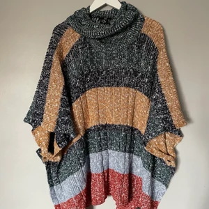 Stickad poncho med hög krage  - Rejäl poncho i bommull från H&M. Storlek XS/S, rymlig och varm! Knäppning i sidorna. Fungerar som klänning!