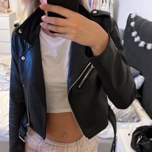 Svart skinnjacka - Säljer denna svarta skinnjacka från pull and bear i storlek s men skulle säga att den är som en xs då den är väldigt liten i storleken. Fin kvalite då den ej är så andvänd. Köparen står för frakten 