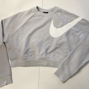 En kortare sweatshirt - Här kommer en kortare sweatshirt från Nike, i storlek S. Beroende på hur lång man är utformas längden olika. En superfin babyblå färg som inte syns så tydligt på bilden.. Använt kanske tre gånger = i superfint skick!