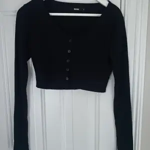 En svart långärmad tröja med knappar på, knappt använd. Mycket bra basic att ha i garderoben o går o matcha med mycket. Tröjan är från bik bok. Frakt betalar du som köpare
