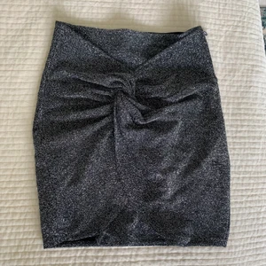 Glittrig omlott kjol - En kort glittrig omlott kjol i storlek xs, från Hm. Använd en gång. Frakt tillkommer!