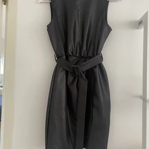 Klänning  - Svart glansig klänning från booohoo, väldigt kort i modellen  Liten i storleken skulle nog passa en 34 