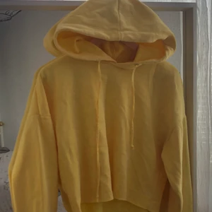 Gul croppad hoodie  - Använd ganska mycket, stor luva, ganska stor i storleken, samt är ganska varm. 