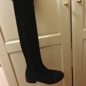 Lårhöga boots - Boots som inte är skadade, lite slitna på undersidan. Jag köpte dessa här på Plick och då var de helt nya. Jag tror att de är från Din Sko. De har justerbara band längst upp.