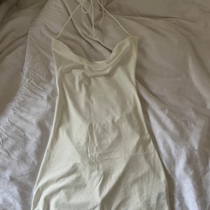 Helt ny vit klänning! Strl S - Helt ny aldrig använd vit tajt figurnära klänning. Strl S! Vattenfallsurringning och öppen i ryggen, knyts i nacken! OBS Kan upplevas genomskinlig. Frakt 52kr🥰