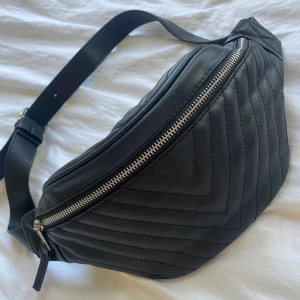 Svart Criss body bag - Säljer min svarta Criss body jag från Stradivarius. Väskan är i skinn med insydda mönster. Knappt använd och därav i ett sprillansnytt skick. 