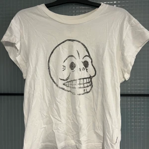  Cheap monday t-shit - Cheap monday t-shirt vit med en döskalle på bröstet. Aldrig använt. Storlek S 