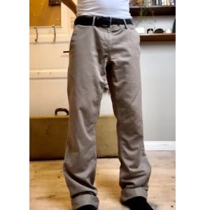 Beiga Loose Chinos - Chinos i beige färg, gott skick, inga märkbara skador med loose/baggy passfrom. Stora i midjan så rekomenderar att använda med skärp samt att dem är ganska långa