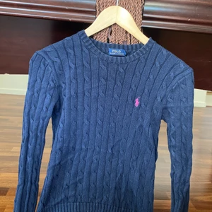 Kabelstickad Ralph Lauren - En kabelstickad marinblå Ralph Lauren tröja i storlek S dam. 