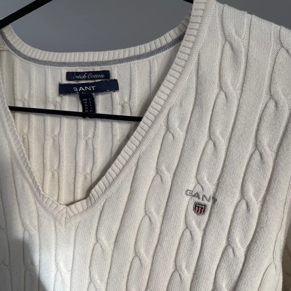 Kabelstickad V-ringad gant tröja i storlek Large.  Använd fåtal gånger  Färg vit/beige . Stickat.