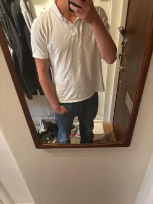 Blå raka jeans från Jack and Jones  - Säljer ett par klassiska blå jeans med raka ben och snygga slitningar på framsidan. Jeansen har fem fickor, normal midja och stängs med dragkedja och knapp. Perfekta till vardagslooken och passar till det mesta storlek 30-30 och har en omärkbar ”slitning” på framsidan .