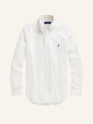 Vit skjorta från Ralph Lauren - Klassisk vit skjorta från Ralph Lauren med lång ärm och knappar framtill. Skjortan har en liten broderad logga på bröstet och är tillverkad i mjuk bomull. Perfekt till både jeans och kostymbyxor.