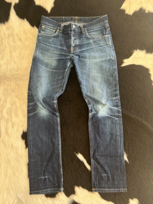 Nudie Jeans Selvage Grim Tim - Tjena, säljer nu dessa tvär feta Nudie Grim Tim selvage jeansen.| Byxorna är i väldigt bra skick samt har snygga lagningar och har storleken W33 och L32.| Dubbelkolla gärna måtten på de sista bilderna.| Bara att höra av er vid frågor eller funderingar.| 