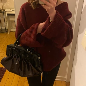 Vintage handväska - Säljer denna superfina väska i glansigt material. Den är svart och lite mörklila/vinröd. Bra skick, använd några gånger💞💞