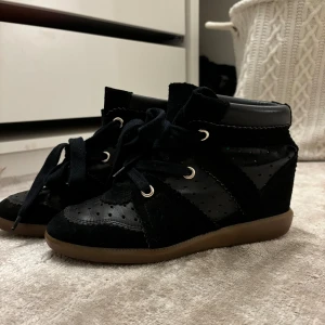 Isabel marant skor!  - isabel marant skor!!!🩷🩷🩷Skorna har en kombination av skinn och mocka material med perforerade detaljer på ovansidan. Sulan är brun och skorna har en hög ankel.