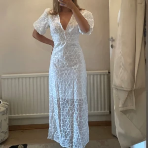Vit sommarklänning  - Klänning i fint chiffong/jacquard tyg i storlek S. Oanvänd. 