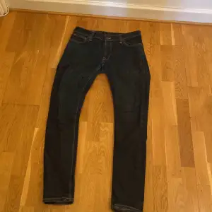Jeans från märket Nudie i storlek 33/32. Fint skick med få slitagemärken på högra bakfickan. Mörkblå färg. 