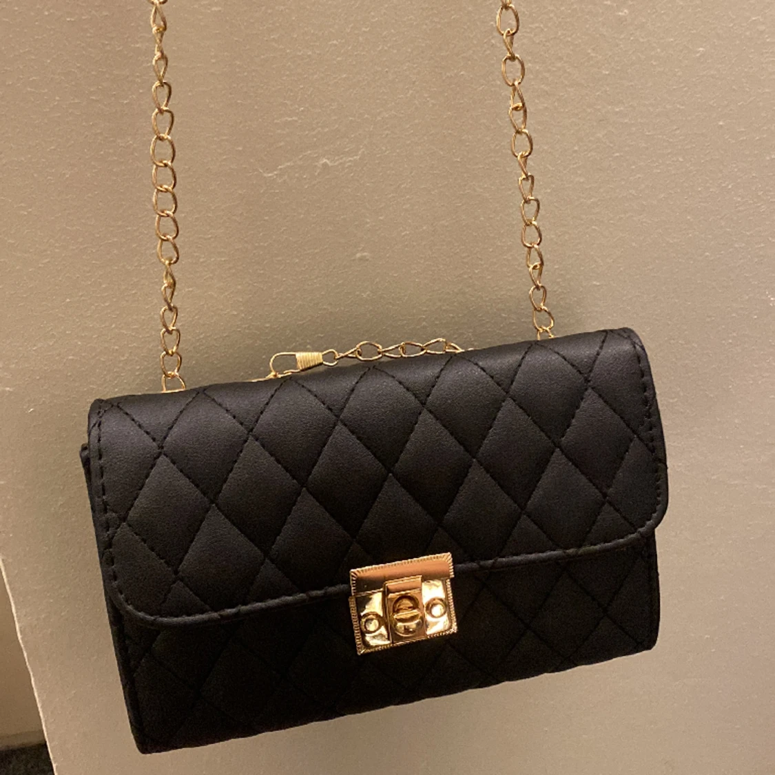 Svart väska med guldkedja 