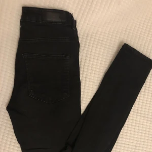 Svarta jenas - Svarta tighta jeans i stretch från bikbok. Hög midja. Sparsamt använda. 
