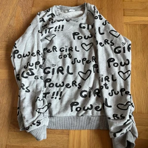 Långärmad  - Grå långärmad tröja med svart text. Insidan är lite speciell men ska vara så. Designen är så. Så den är inte sönder utan det ska vara så. 