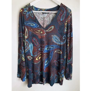Långärmad paisley topp, L 44/46, mörkblå, mörkröd, bohemisk, boho, blus, hippie - Långärmad topp med paisleymönster, v-ringad, trumpetärm, lätt utställd modell. Något urtvättad. Mått får ej plats - fråga gärna!
