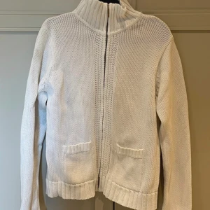 Vit stickat kofta - Med dragkedja. Köpt secondhand därav ett litet hål