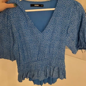 Topp - Blå blommig topp från bikbok! Resår i midjan