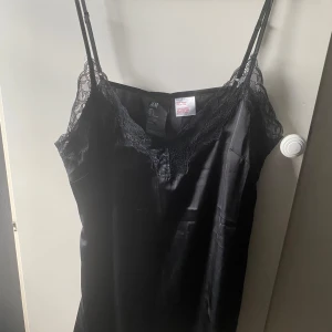 Nattlinne, H&M  - Svart nattlinne från H&M, använd 1-2 gånger. Är precis som ny, säljer då jag inte får användning för den. Inga skador eller något liknande. Har fin spets upptill, bara fram dock. Tyget är rätt så genomskinligt. Finns på flera sidor. 