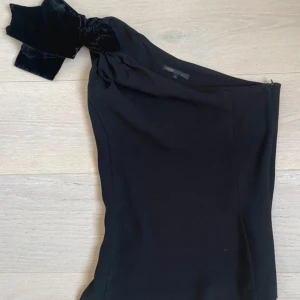 One shoulder topp Maje - Superfin one shoulder topp från Maje med rosett på axeln i superfint skick. Tröjan har haft en pytteliten öppning i sömmen men den har sytts igen och syns inte alls. Tröjan är i superfint skick utan något tecken på användning🩵🩵