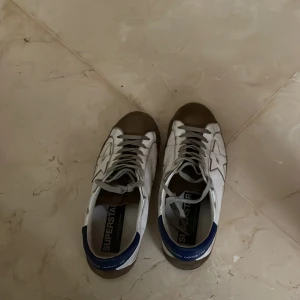 Golden goose skor  - Hej jag säljer dessa snygga och sköna skor av märket golden goose. Dem är använda på ett sparsamt sätt. Och är i skick 8/10 slitnigar är designen på skorna. Ny pris 5200. Fråga vad som helst pris går att diskutera vid snabb affär. Storlek 41.