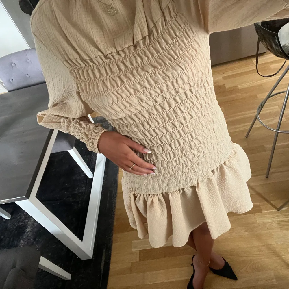 Söt beige klänning från H&M aldrig använd💛 st.34/xs passar även small/ 36 och upp då den är väldigt stretchig i materialet . Klänningar.