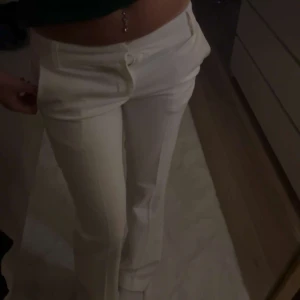 Lågmidjade kostymbyxor  - Vita lågmidjade kostymbyxor från Bikbok. Har använd dom typ 2 gånger så det är inga fel på dom.
