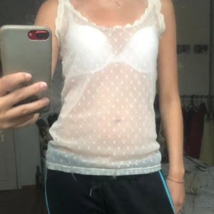 Genomskinlig topp - Ett genomskinlig topp bed små blommor kopt secondhand!