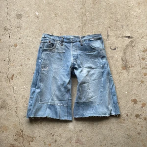 Patch Jorts - Crafted from vintage denim, this piece features multiple pairs of different jeans entirely reconstructed with a inner lining for comfort.