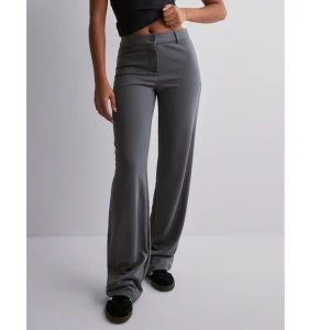 Gråa kostymbyxor - Säljer dessa ursnygga lågmidjade kostymbyxor från Nelly och är i mjukare material. Slutsålda på hemsidan! 