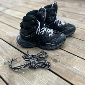 Balenciaga High Track Sneakers - Authentic from NK Stockholm.  Contact if more infor in needed.  Debuting all in black, the multifaced-design is individually made with a washed, vintage effect for a pre-loved feel. *Upper: fabric *Closure: laseup *Item number: P00362116
