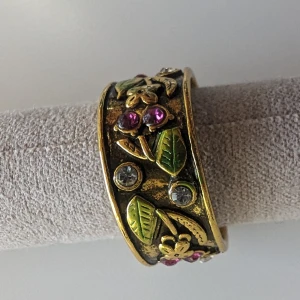 guldiga ring, storlek 10  -  guldiga ring med fina detaljer och strass är en fantastiskt elegant tillägg till din smyckesamling. Tillverkad av en okänd metall, den här ringen ä för alla som älskar att lysa upp sin stil. I mycket fint skick  Postar mellan 1-3 dagar efter köpet 