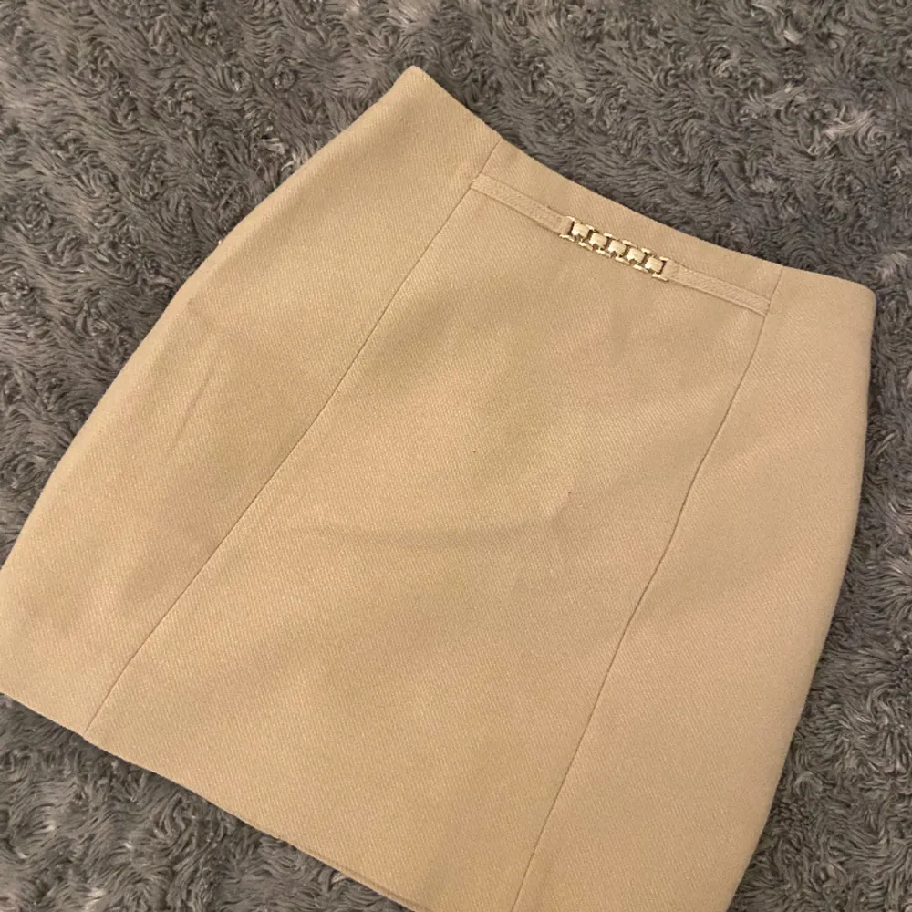 En beige kjol med guld Detaljer från H&M! Den är för liten på mig, tvättad och inga fläckar!. Kjolar.
