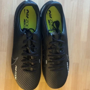 Nike Mercurial Vapor 15 - Black - Ordinarie Pris:- 1099 Oanvända, de passade inte. Lättviktiga design som gör att du kan röra dig ännu snabbare över fotbollsplannen. Passar spel både natur- och konstgräs. Priset kan vi komma överens om.