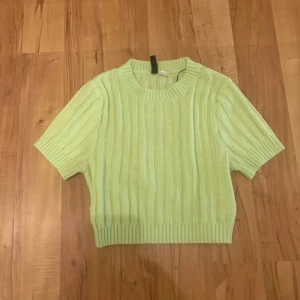 Ljusgrön stickad tröja från H&M Divided - En ljusgrön stickad tröja från H&M Divided med korta ärmar och ribbstickade detaljer. Knappt använd💕