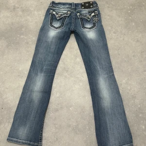 Miss me low waist bootcut jeans - Miss me low rise bootcut storlek W25 L30. Passar mig som har XS. Dekorerat med stenar på framsidan och bakfickorna. Längd: 96 cm, innerben: 75 cm, midja: 32 cm (kan töjas till 34 cm).  Kan sänka till 1000 kr vid snabb affär