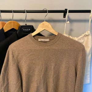 Beige kashmirtröja från Zegna - Exklusiv beige tröja i 100% kashmir från Ermenegildo Zegna. Klassisk rund halsringning och långärmad modell med mjuk, lyxig känsla. Perfekt för dig som vill ha en stilren och tidlös look med premiumkänsla. Kvalitet i klass med Loro piana och brunello cucinelli. Sitter som en M.